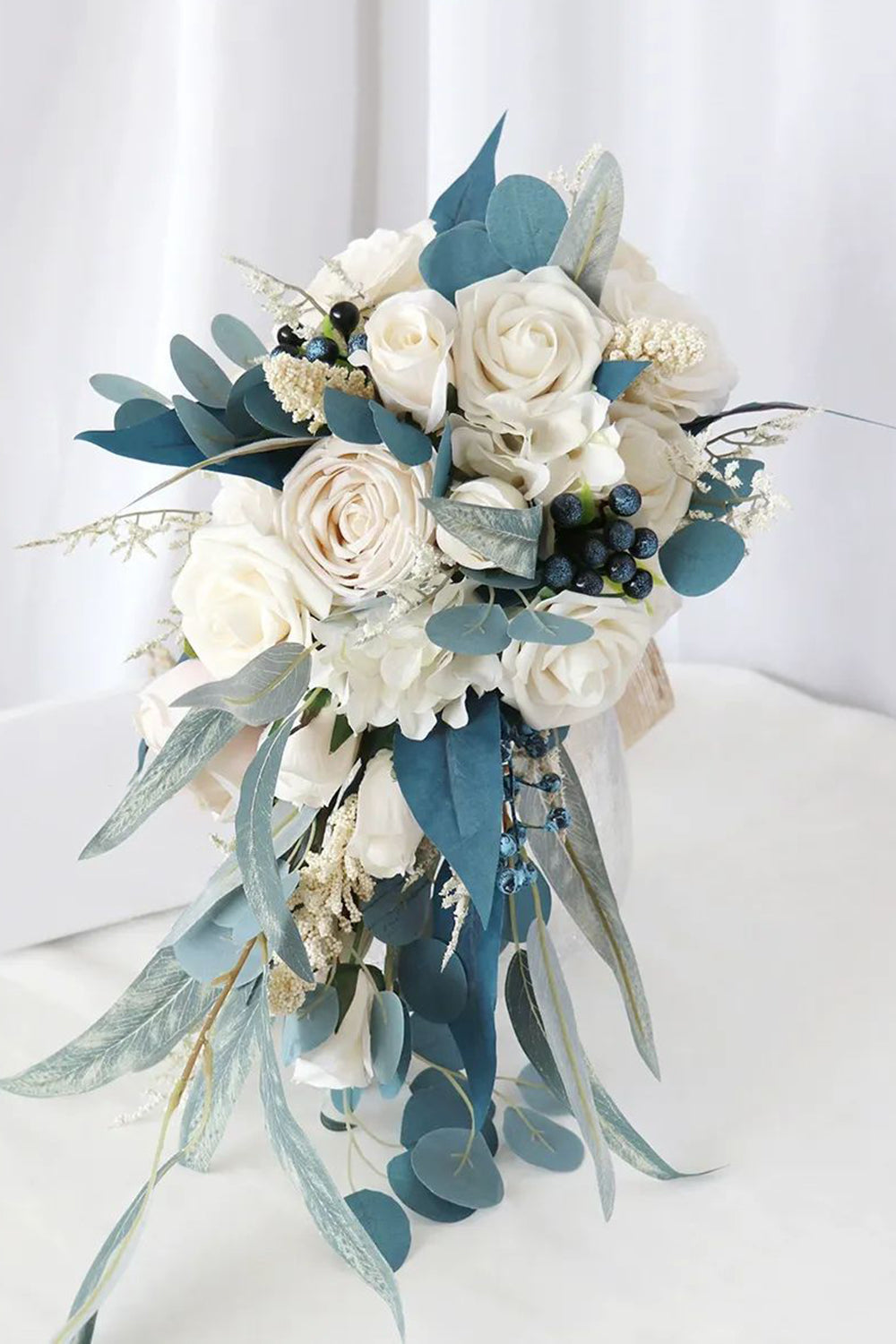 White and Blue Hand Holding Bridal Bouquet