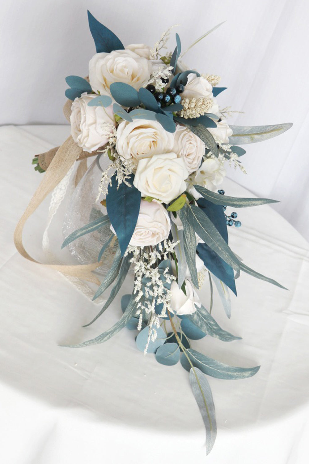 White and Blue Hand Holding Bridal Bouquet