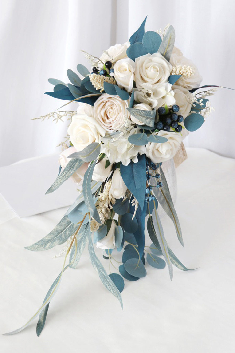 White and Blue Hand Holding Bridal Bouquet